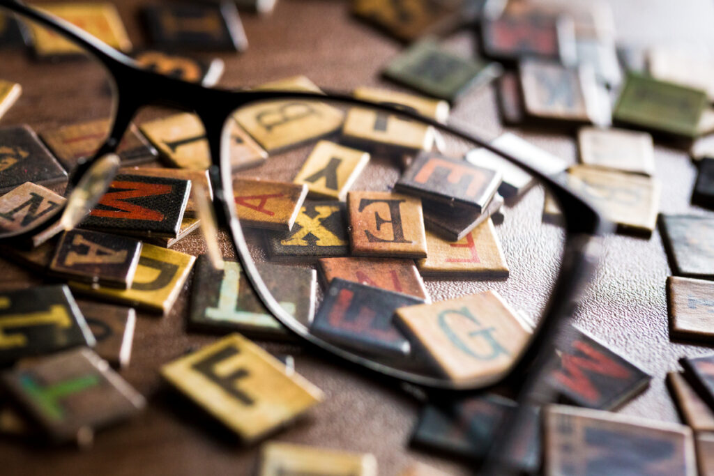 glasses and color letter tiles