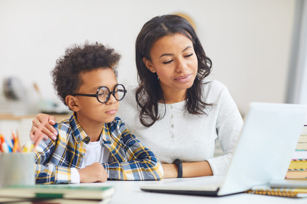 mother and son using laptop in support of virtual learning