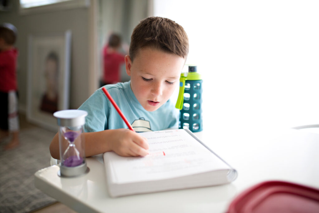 boy writing on a book