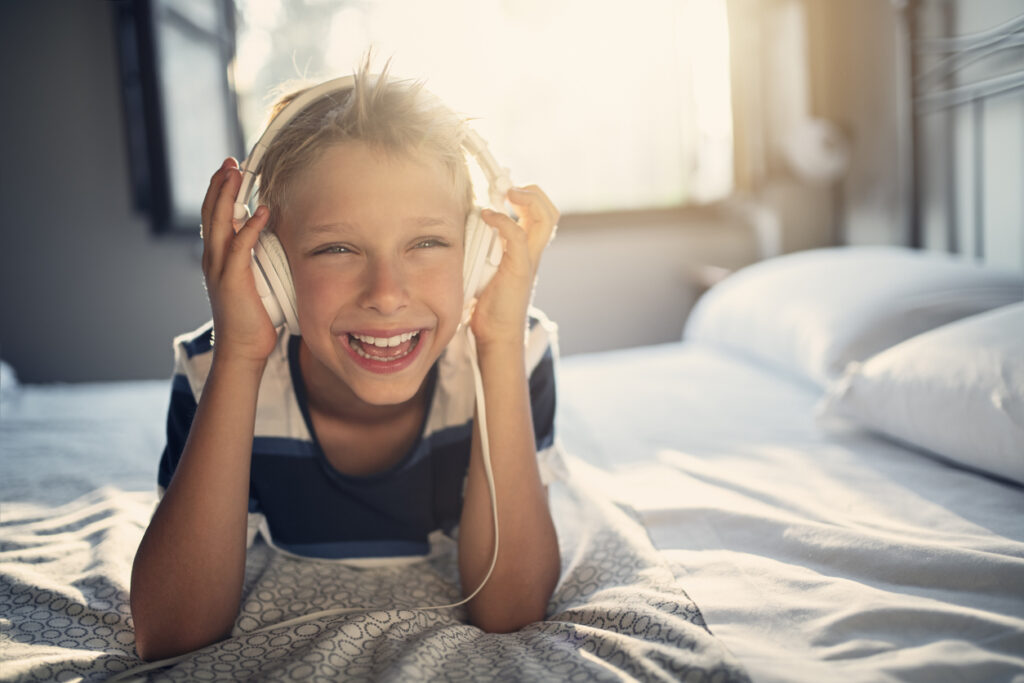 Little boy in headphones listening to music